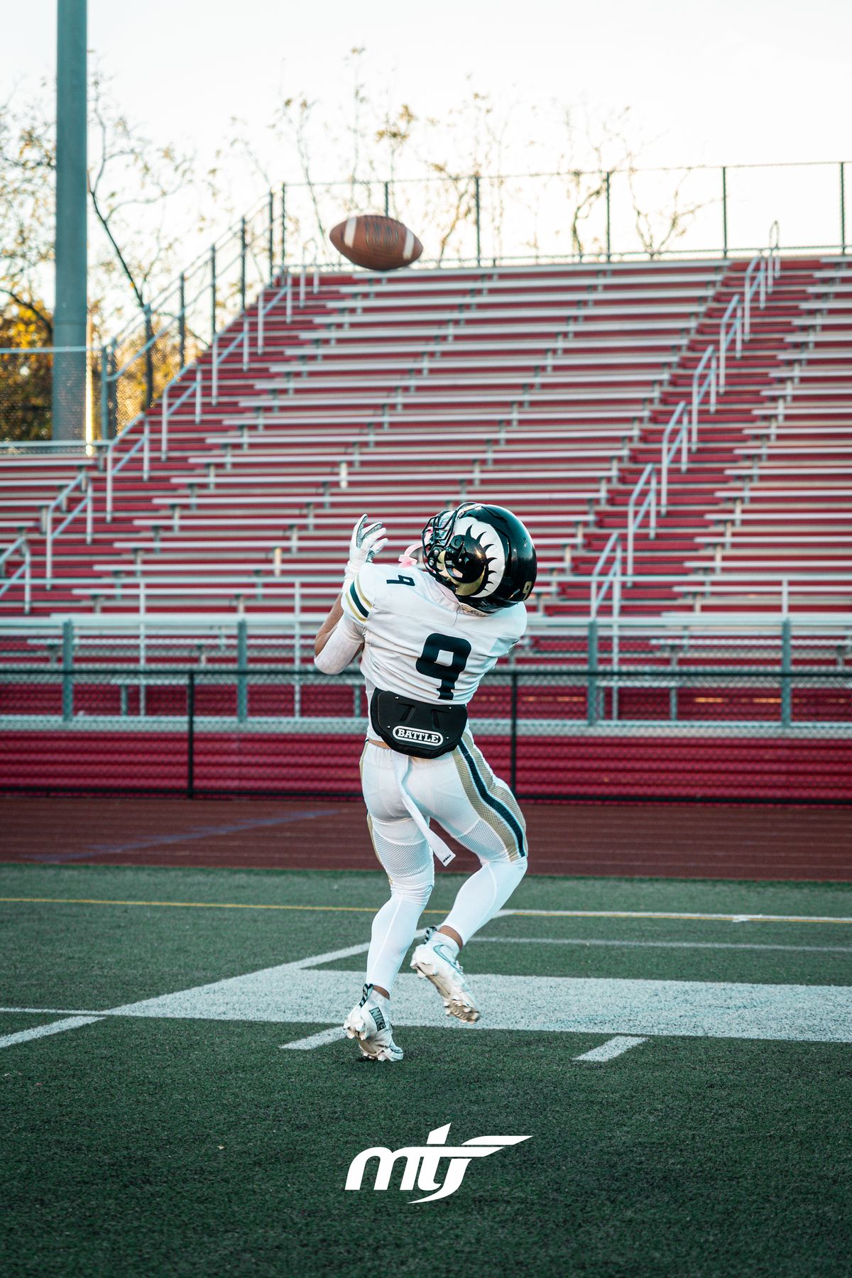 Football receiver tracking the ball into his hands