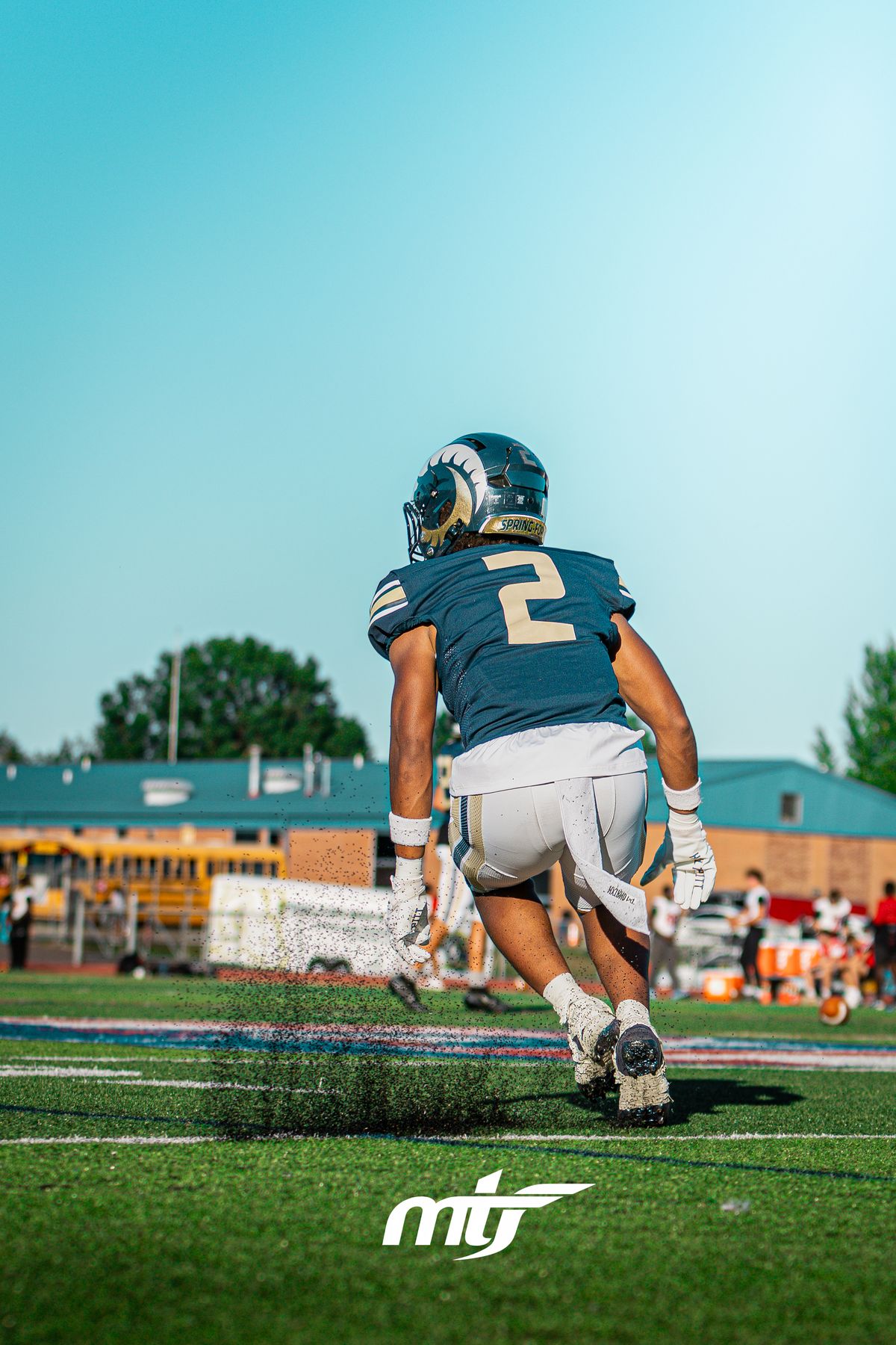 Running back breaking downfield under a clear sky