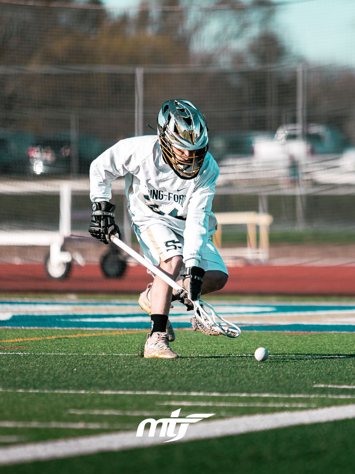 Lacrosse player scooping up a ground ball