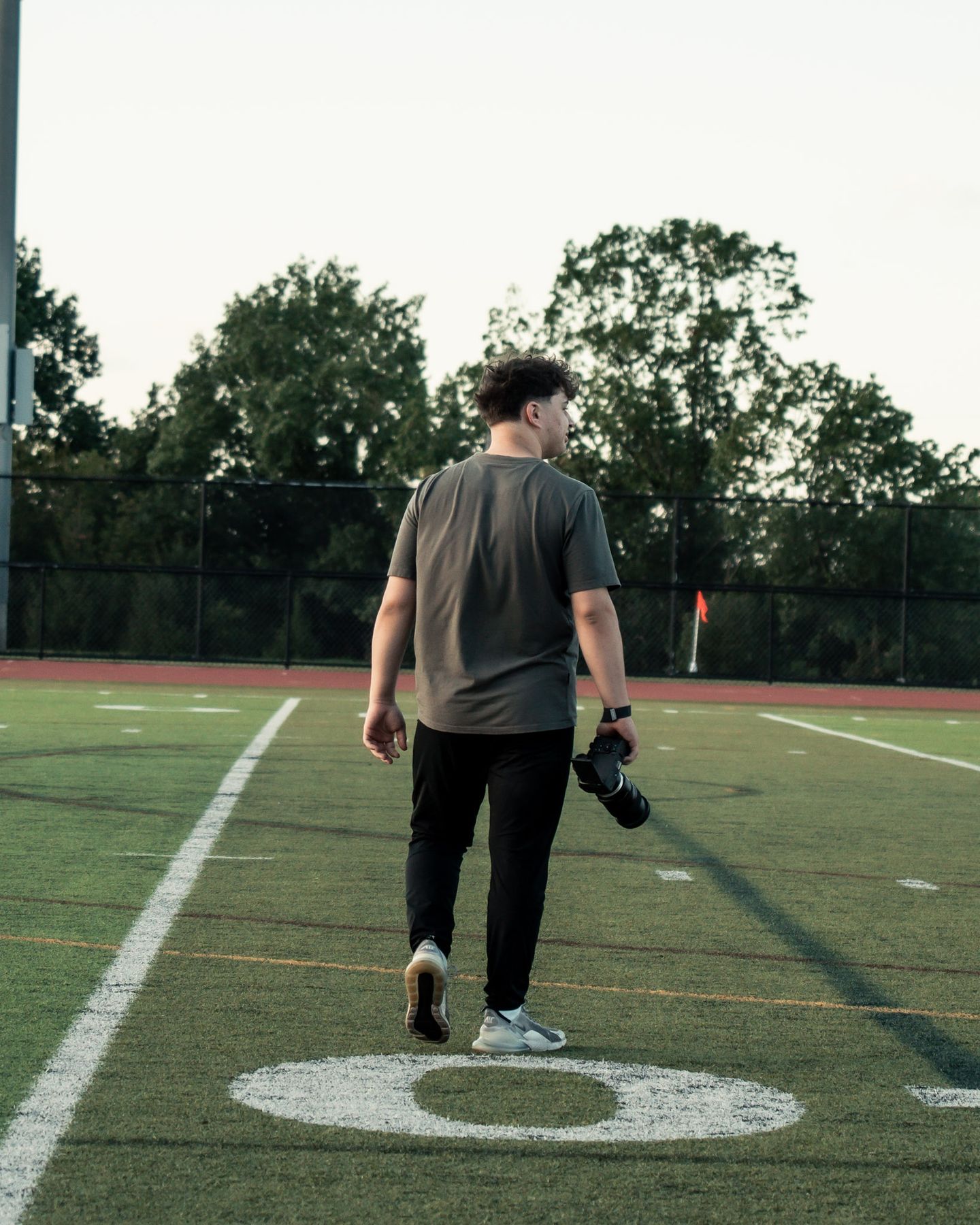 Max walking out across the field, camera in hand