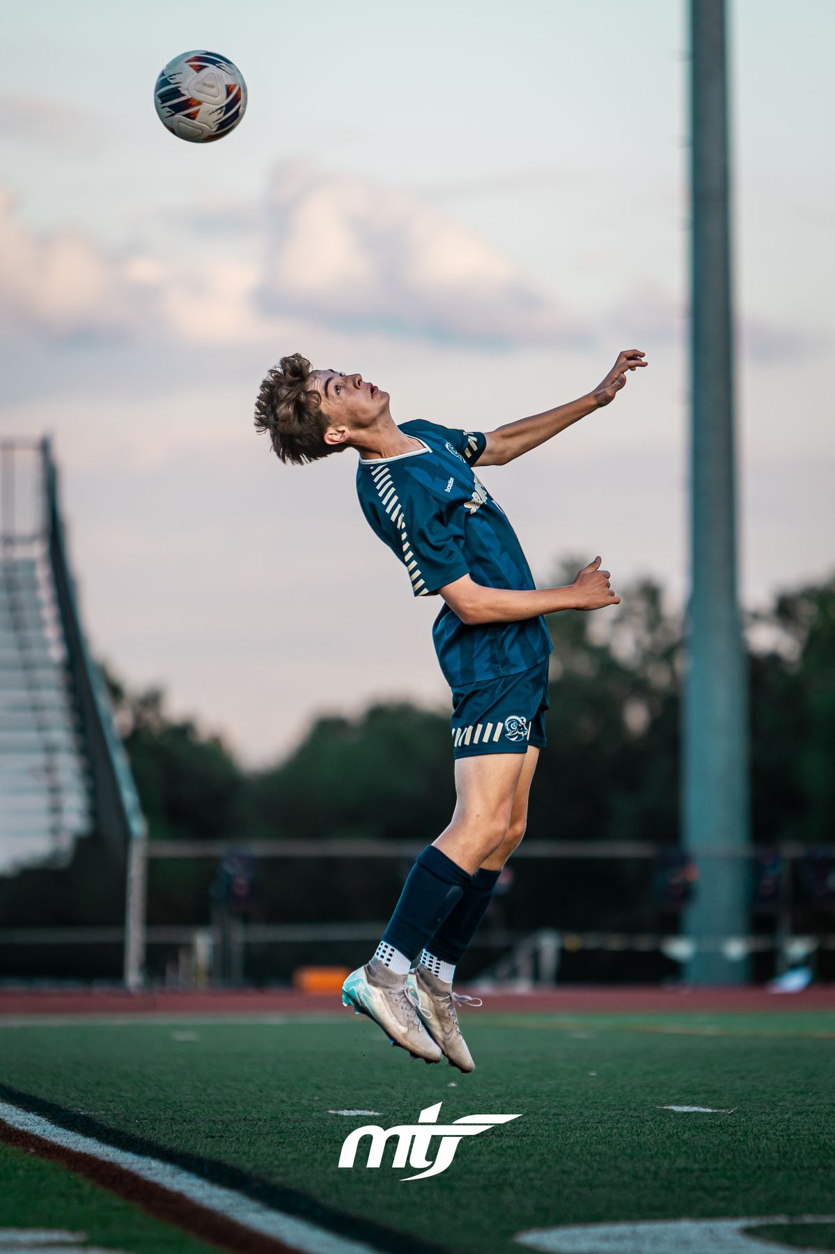 Soccer player leaping to head the ball