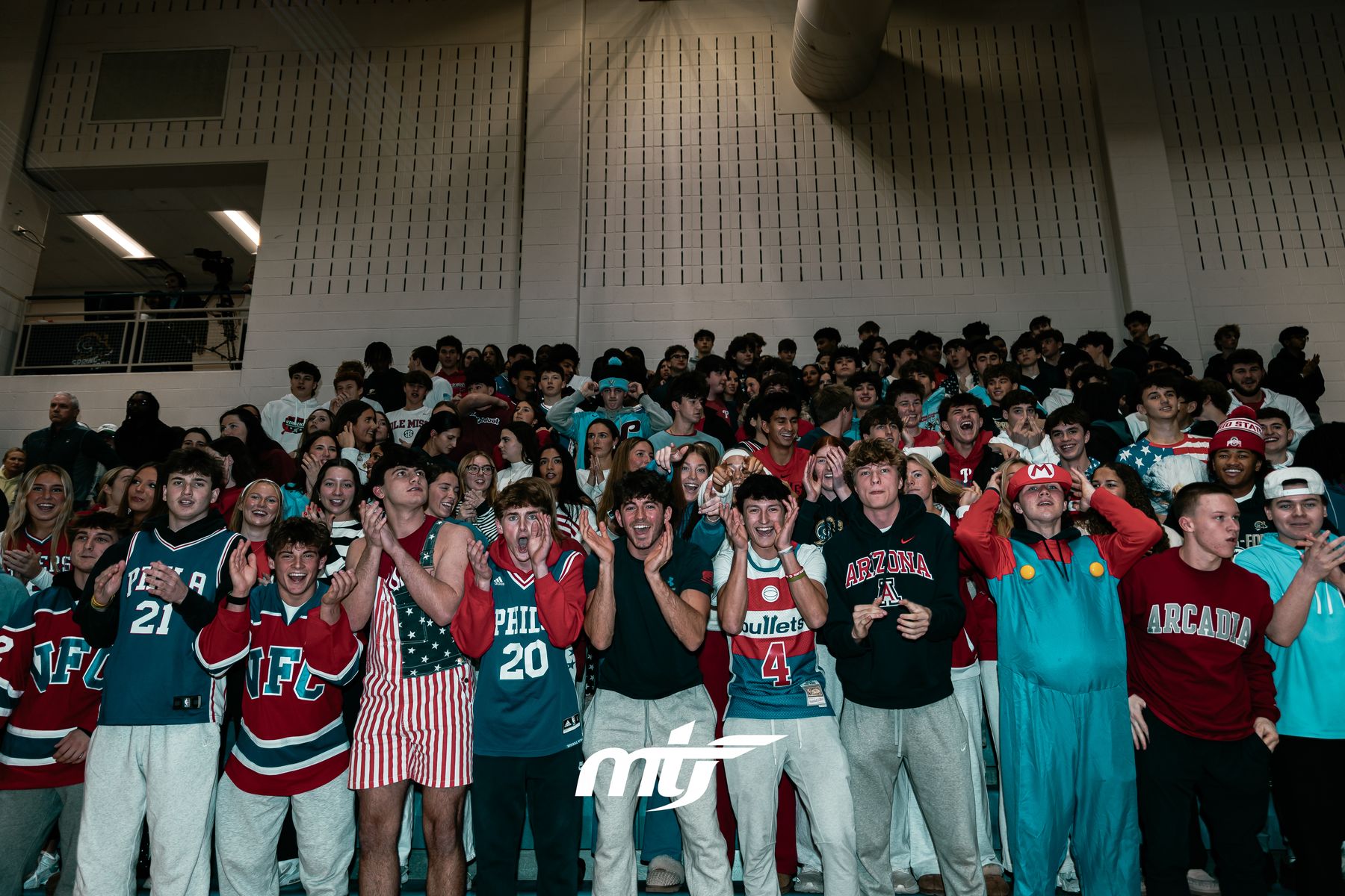 Packed student section cheering in the stands